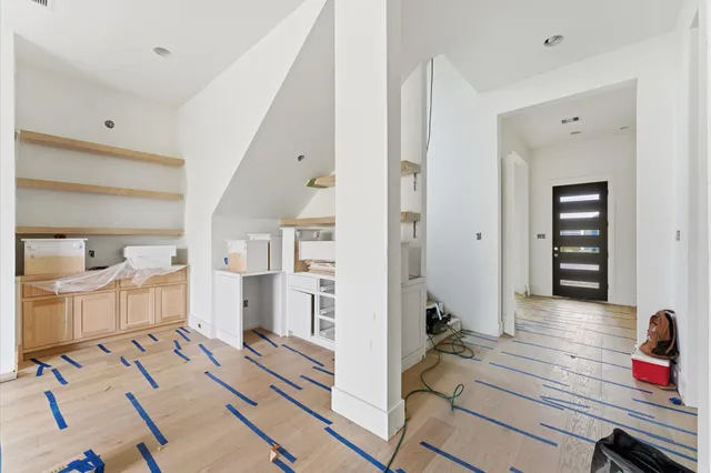 a view of a bedroom with wooden floor and entryway