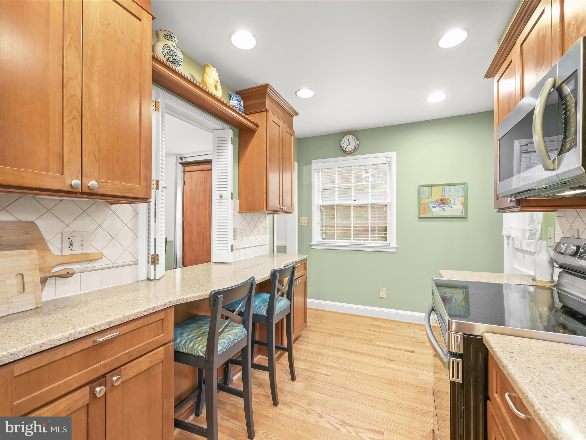 4005 Clagett Road Hyattsville, MD 20782 - Photo 11 of 50 a kitchen with stainless steel appliances granite countertop a stove top oven a sink dishwasher and cabinets with wooden floor