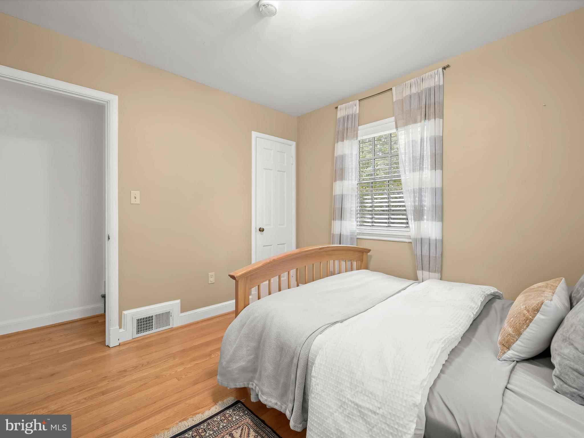 4005 Clagett Road Hyattsville, MD 20782 - Photo 21 of 50 a bedroom with a bed and wooden floor
