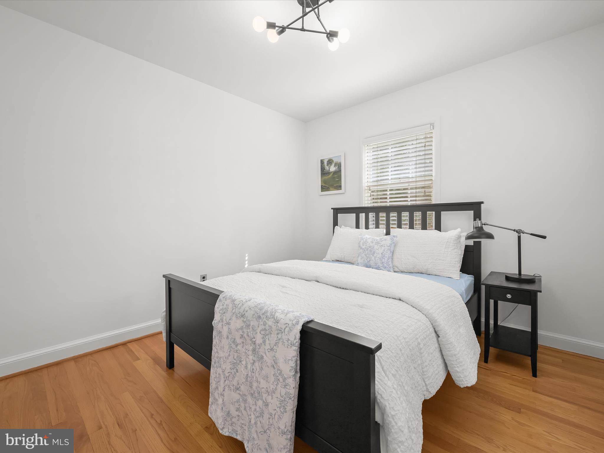 4005 Clagett Road Hyattsville, MD 20782 - Photo 22 of 50 a bedroom with a bed and wooden floor