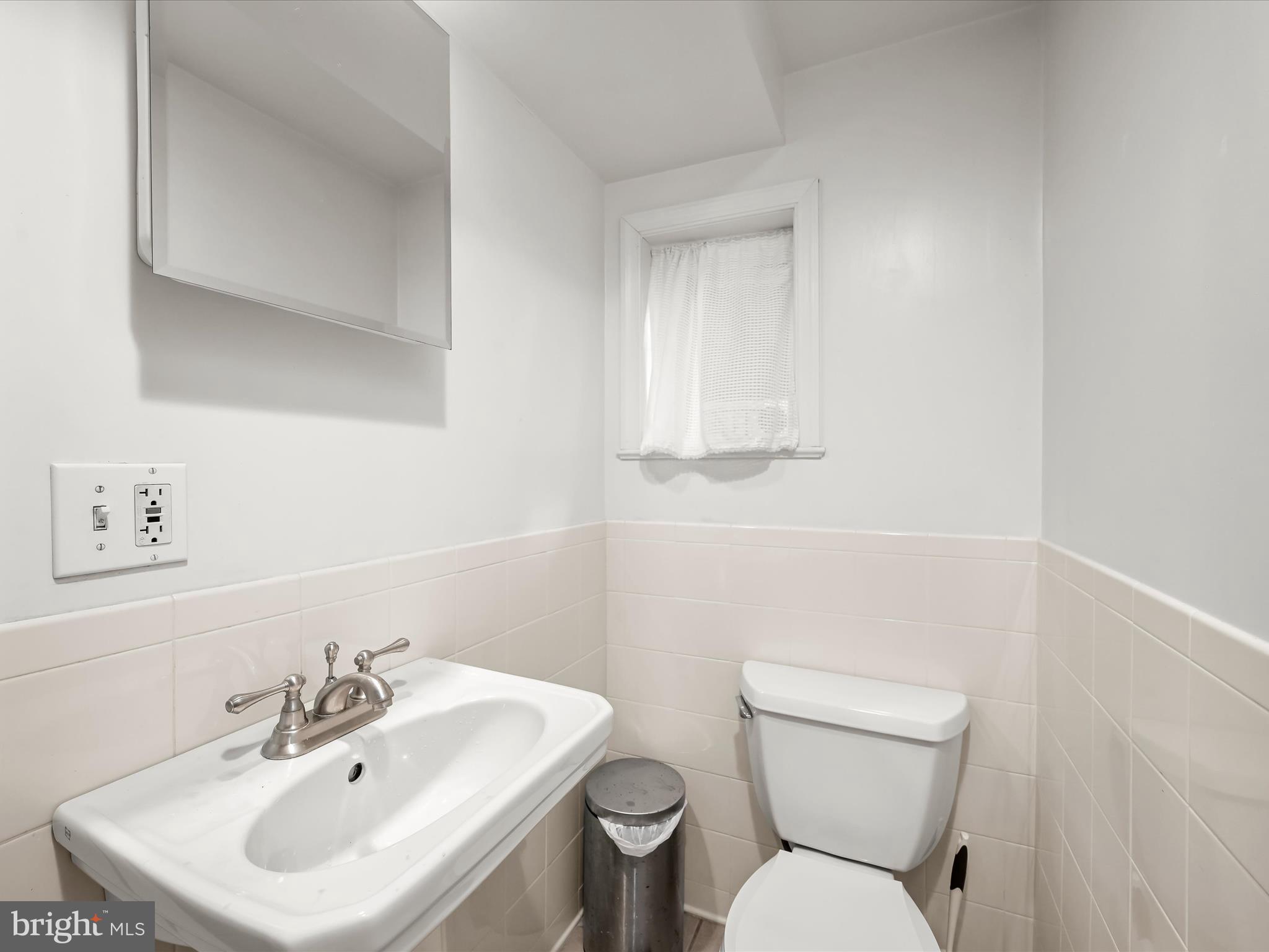 4005 Clagett Road Hyattsville, MD 20782 - Photo 31 of 50 a bathroom with a toilet sink and mirror