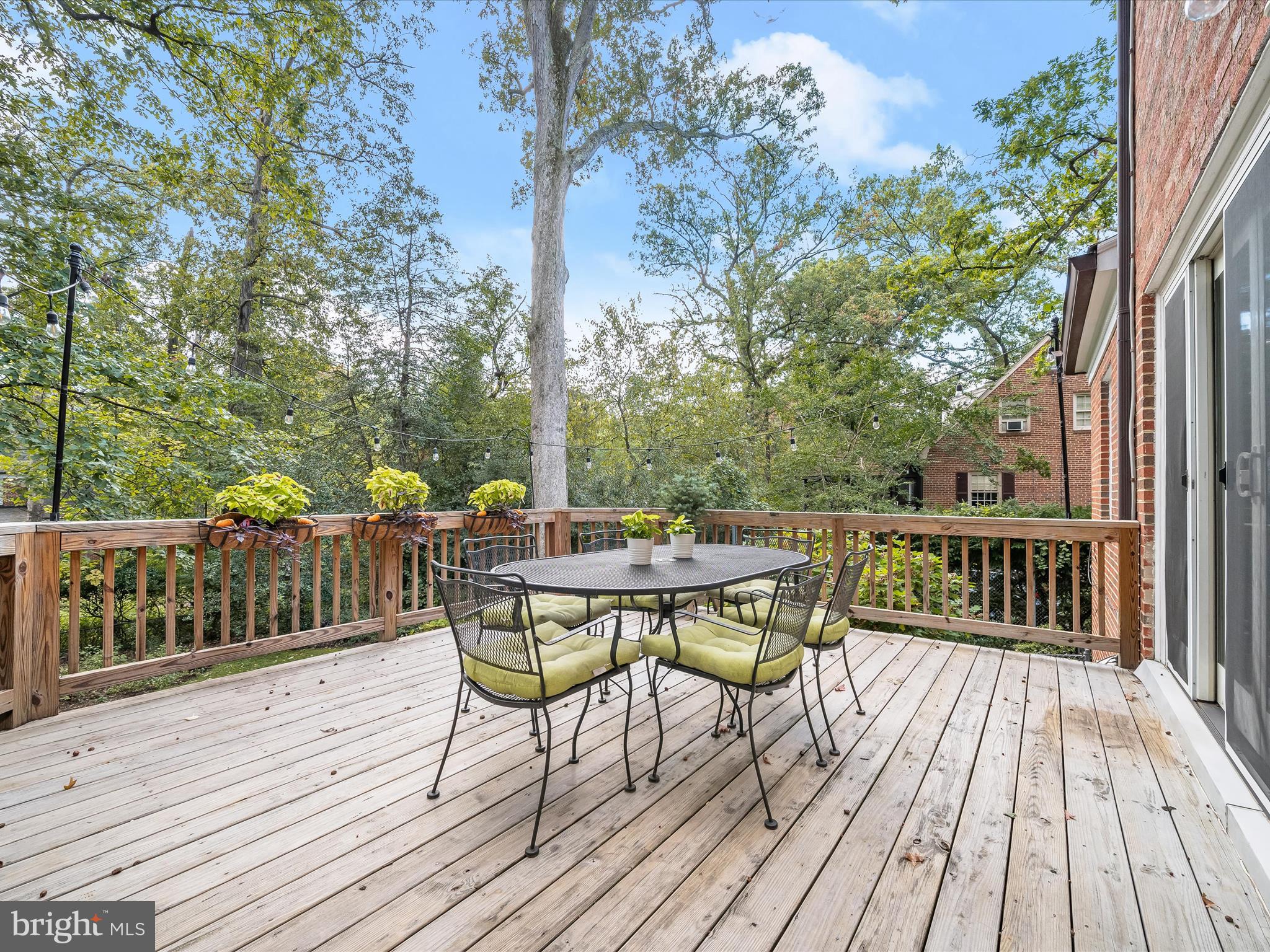 4005 Clagett Road Hyattsville, MD 20782 - Photo 35 of 50 a view of balcony with wooden floor outdoor seating and yard in the back