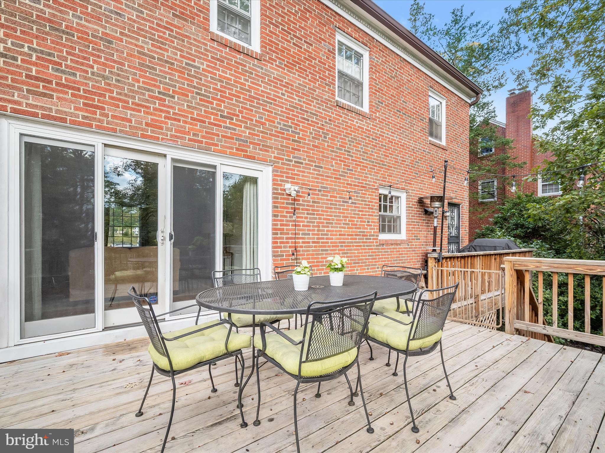 4005 Clagett Road Hyattsville, MD 20782 - Photo 37 of 50 a view of a patio with table and chairs and wooden floor