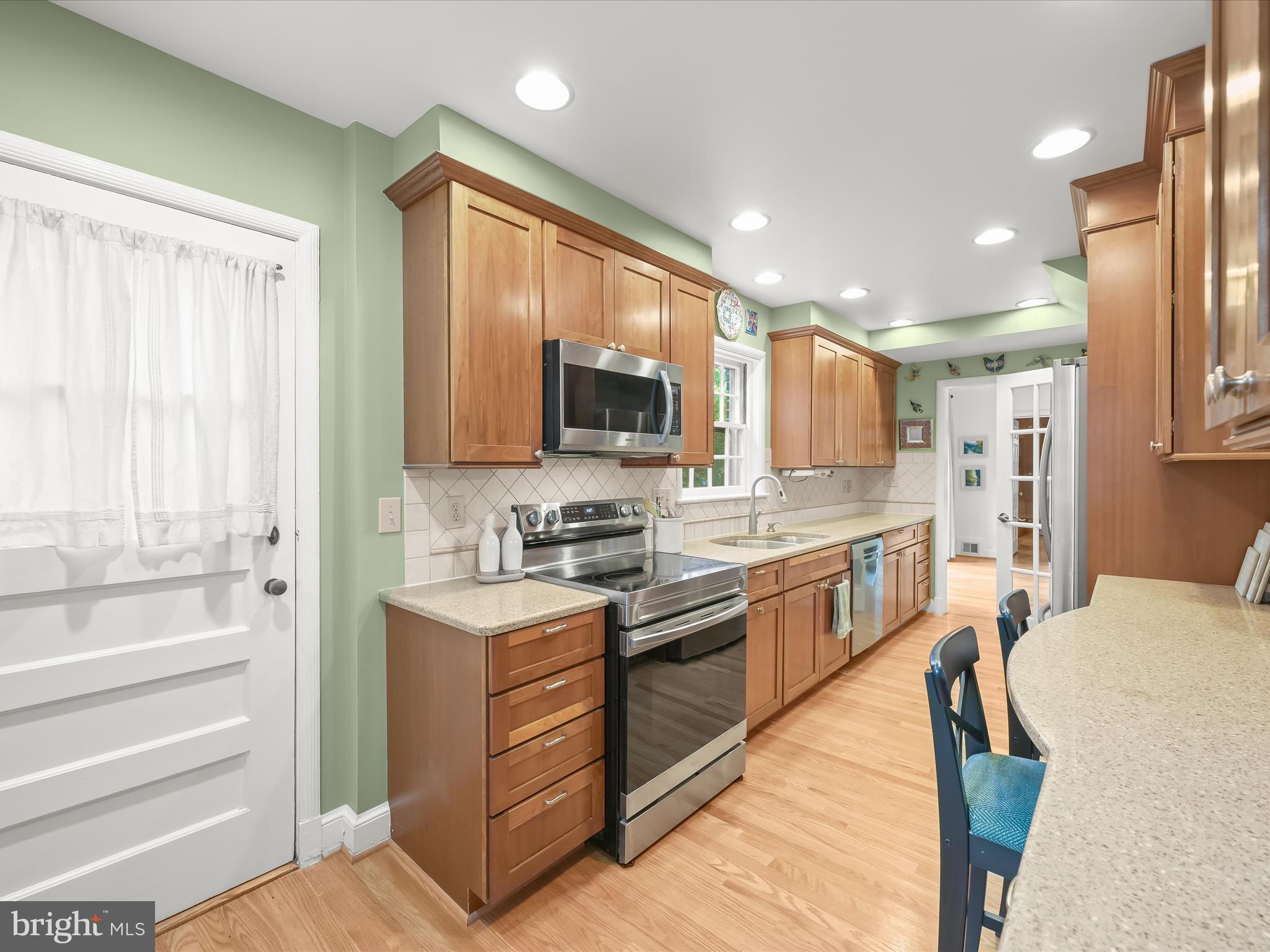 4005 Clagett Road Hyattsville, MD 20782 - Photo 9 of 50 a kitchen with stainless steel appliances granite countertop a refrigerator a stove top oven a sink and dishwasher with wooden floor