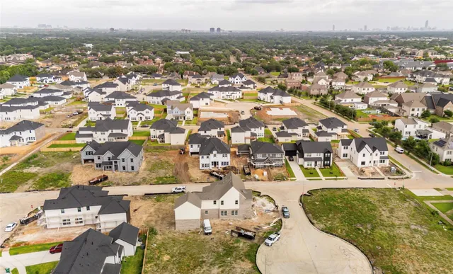 an aerial view of residential houses with outdoor space