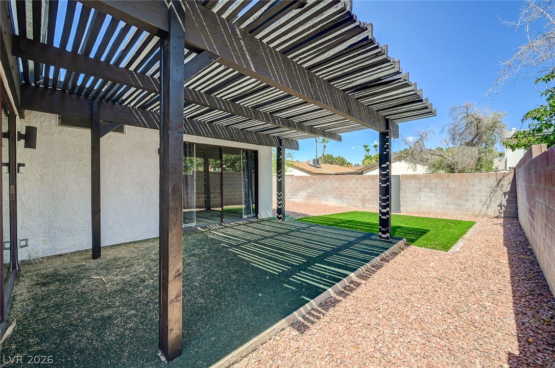 4840 Summerhill Road Las Vegas, NV 89121 - Photo 40 of 56 A spacious pergola covers a patio area, perfect for enjoying sunny days in the private yard.