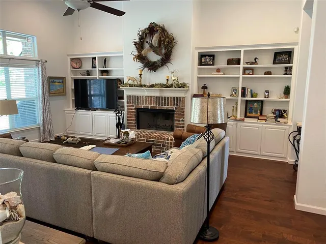a living room with furniture a fireplace and a flat screen tv