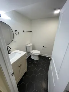 a bathroom with a sink a toilet and a mirror