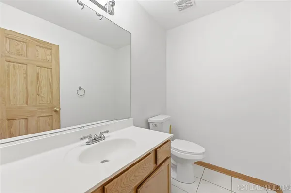 a bathroom with a sink a toilet and vanity