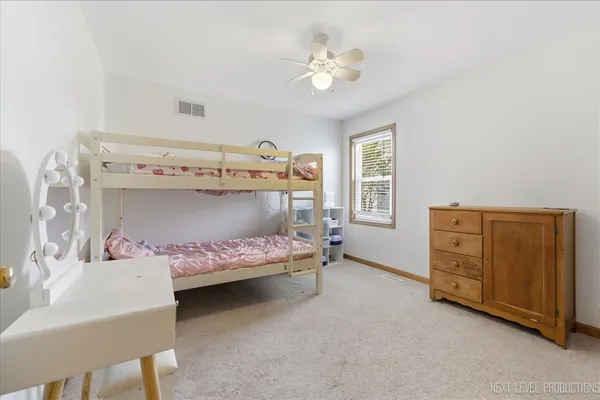 a bedroom with a bed and a dresser