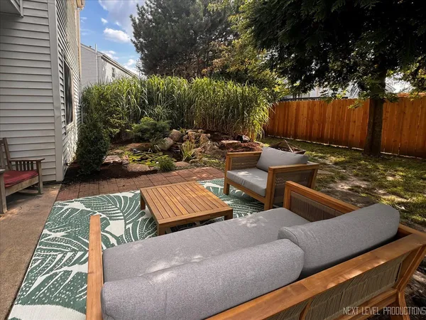 a view of a couches in patio of back yard