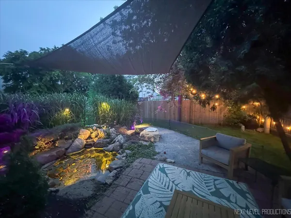 a view of a backyard with plants and a patio