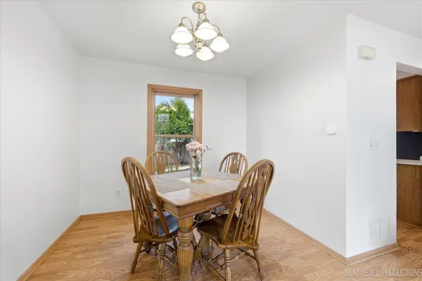 a view of a dining room with furniture and chandelier