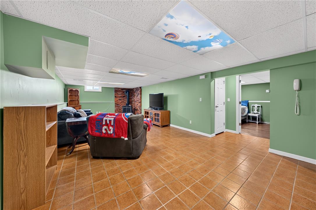 1307 Klinerd Road Pennsburg, PA 18073 - Photo 24 of 53 Tiled flooring and a brick-surround wood stove anchor this versatile lower-level living area.