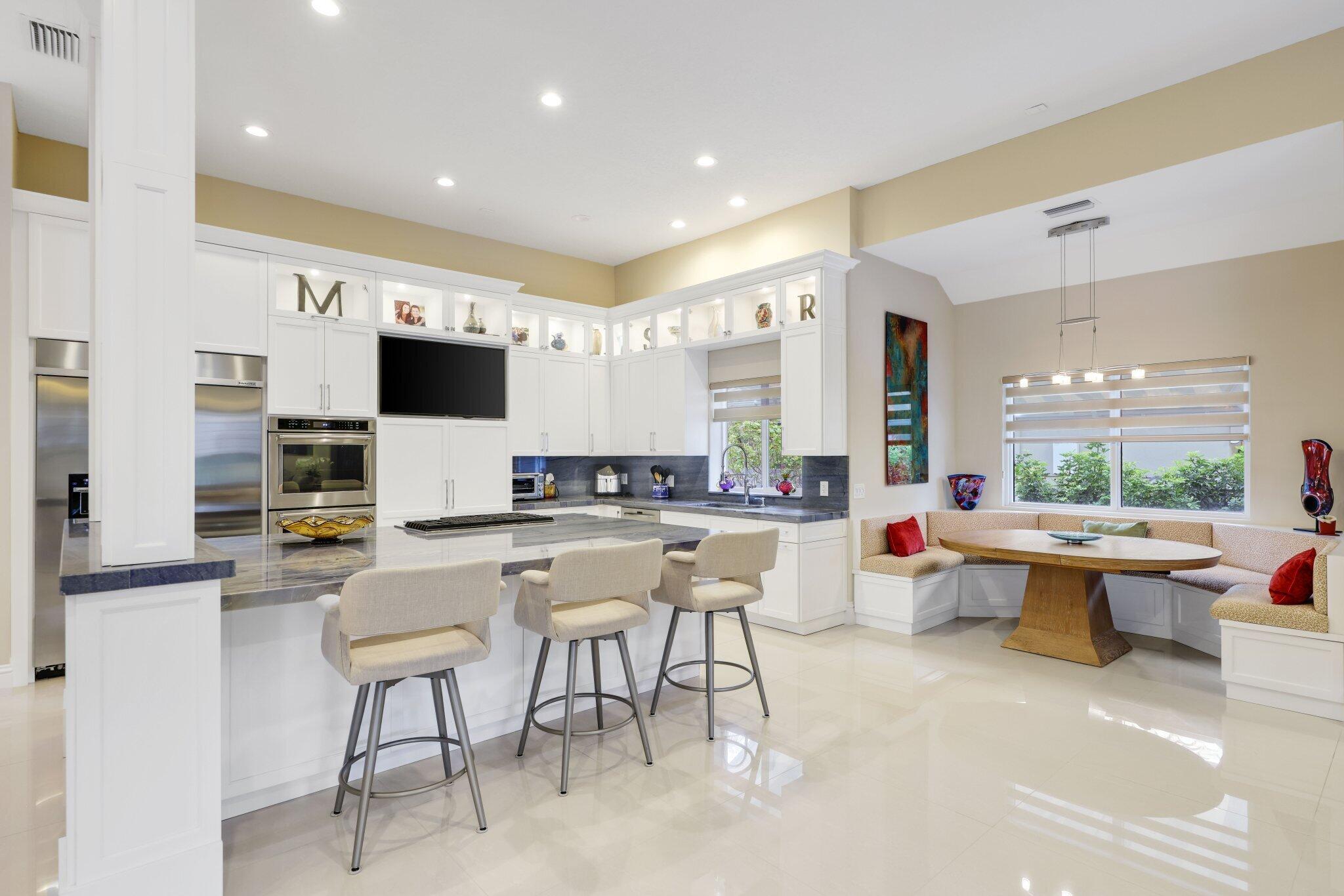7039 Mandarin Drive Boca Raton, FL 33433 - Photo 16 of 52 a large white kitchen with a large window and furniture
