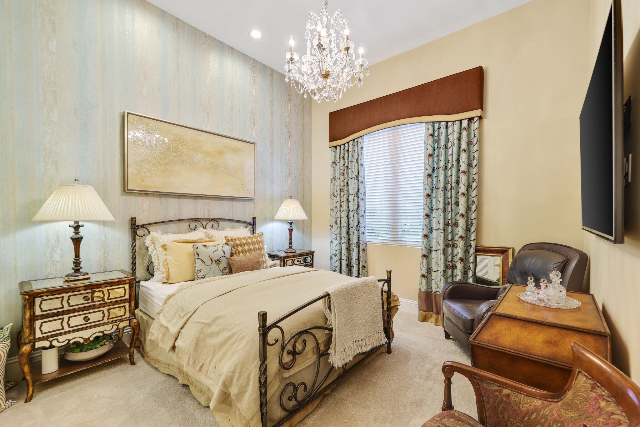 7039 Mandarin Drive Boca Raton, FL 33433 - Photo 26 of 52 a bedroom with a bed and a chandelier