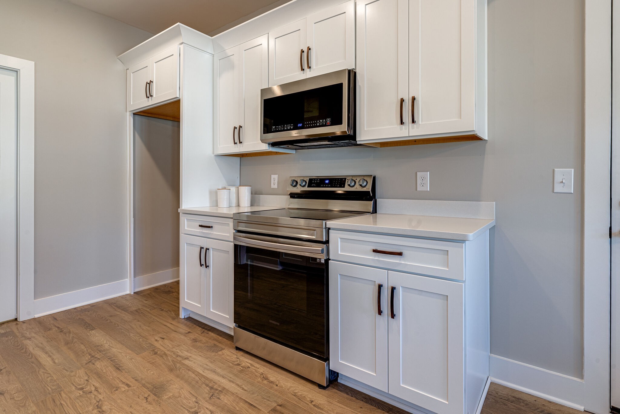 1020 Sycamore Ridge West, Unit 41 Burns, TN 37029 - Photo 39 of 60 a kitchen with stainless steel appliances granite countertop a stove a microwave and a refrigerator