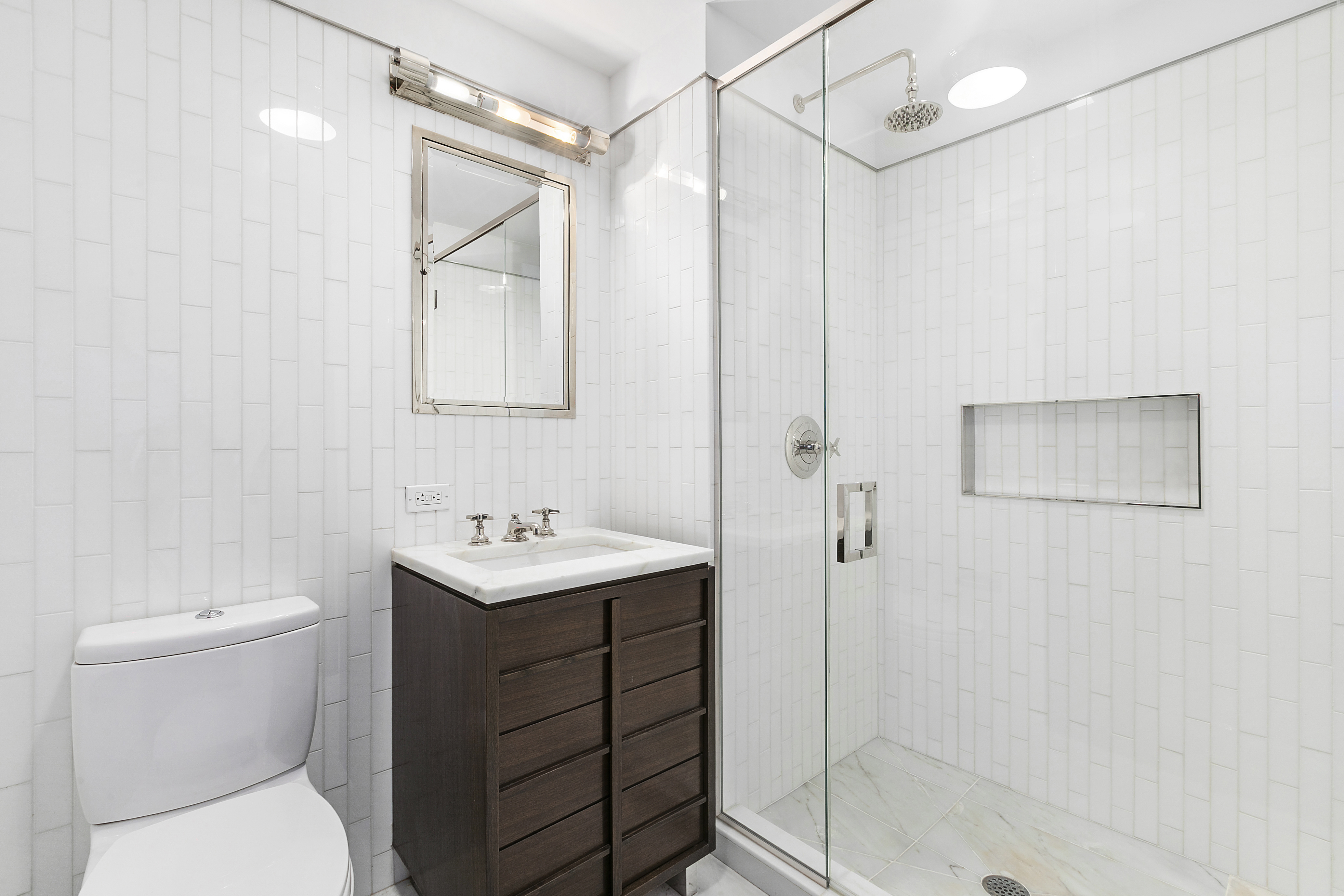 151 East 85th Street, Unit 6B Manhattan, NY 10028 - Photo 2 of 10 a bathroom with a sink a toilet and shower