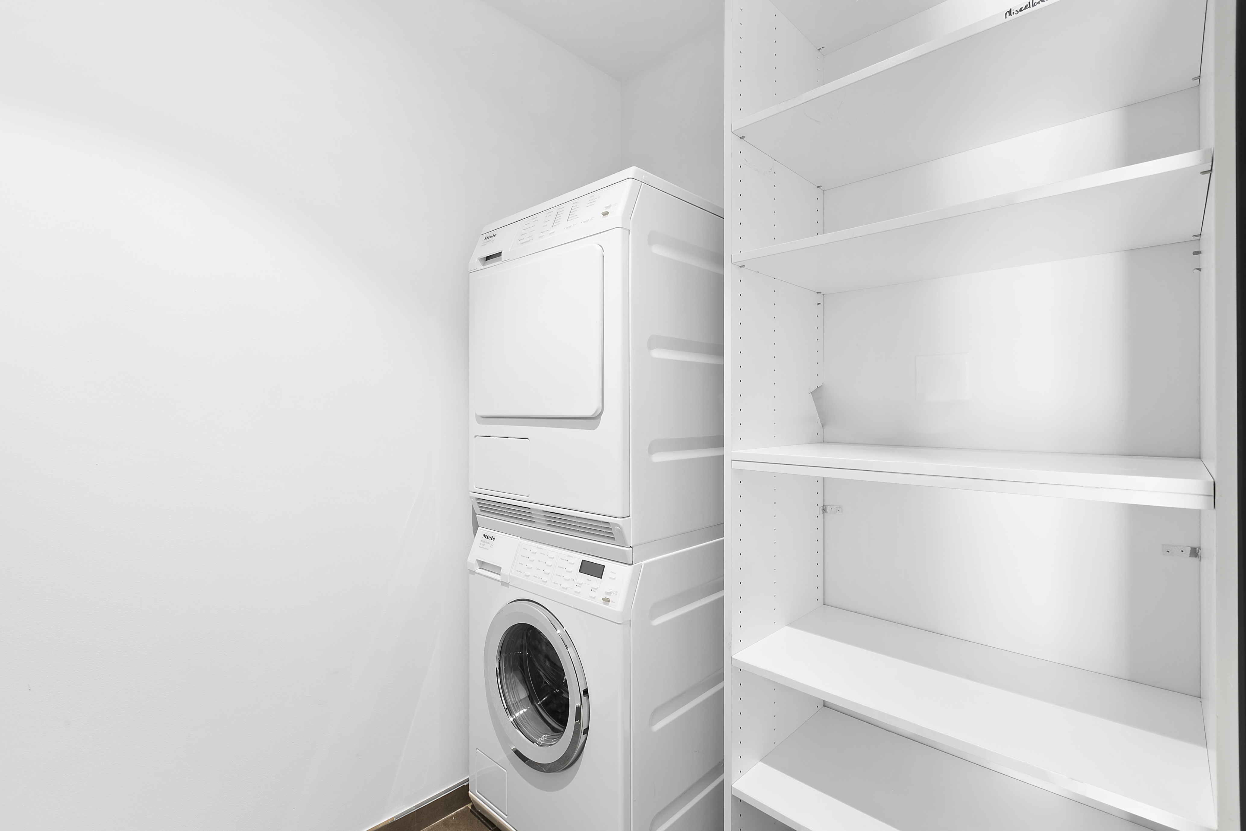 151 East 85th Street, Unit 6B Manhattan, NY 10028 - Photo 9 of 10 a utility room with dryer and washer