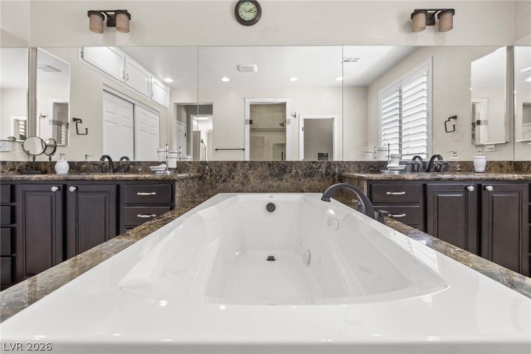 8431 Durango Ranch Court Las Vegas, NV 89113 - Photo 30 of 49 Relax in this inviting primary bathroom featuring a large soaking tub and ample counter space.