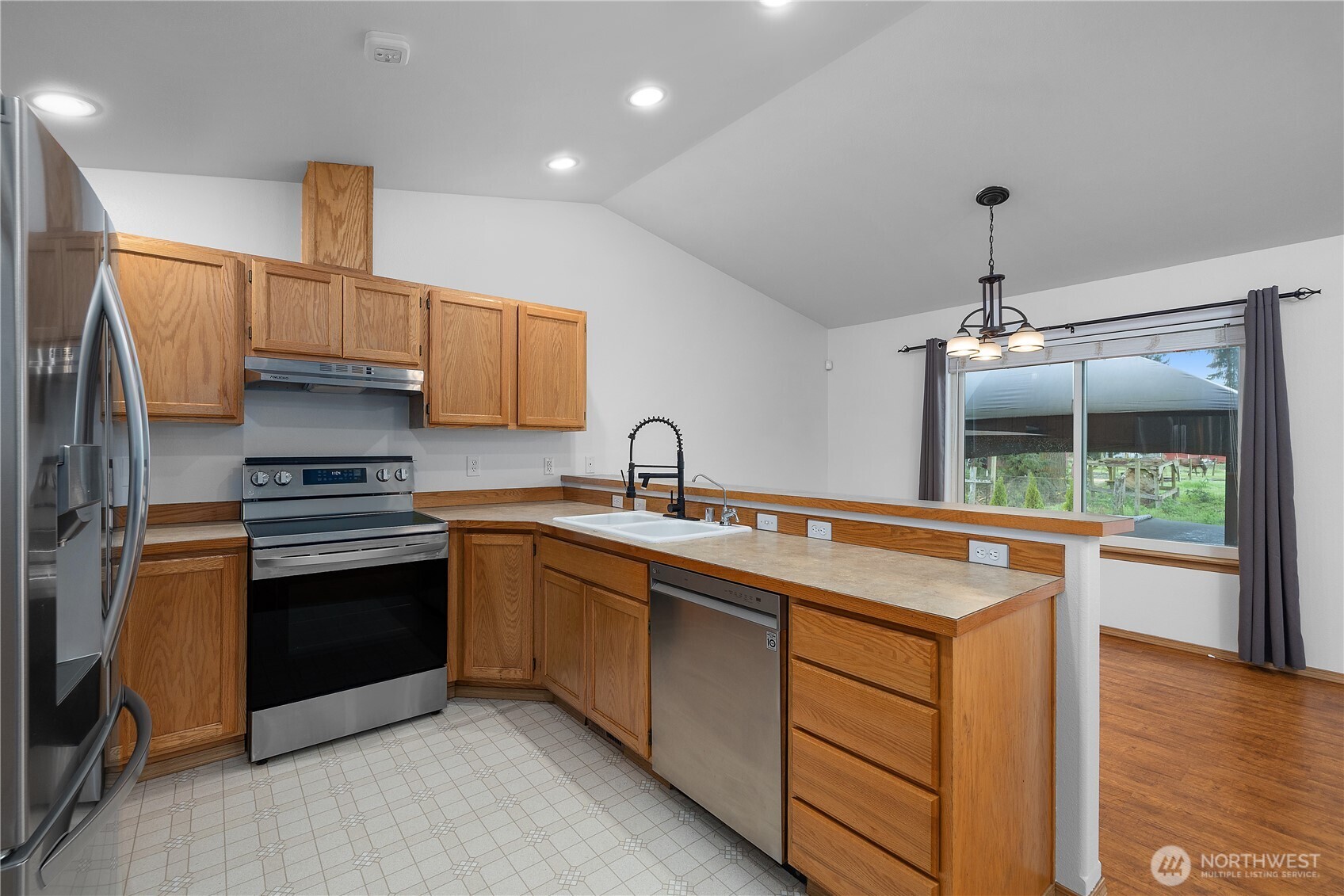 7606 187th Avenue Southwest Rochester, WA 98579 - Photo 11 of 28 a kitchen that has a sink and a stove