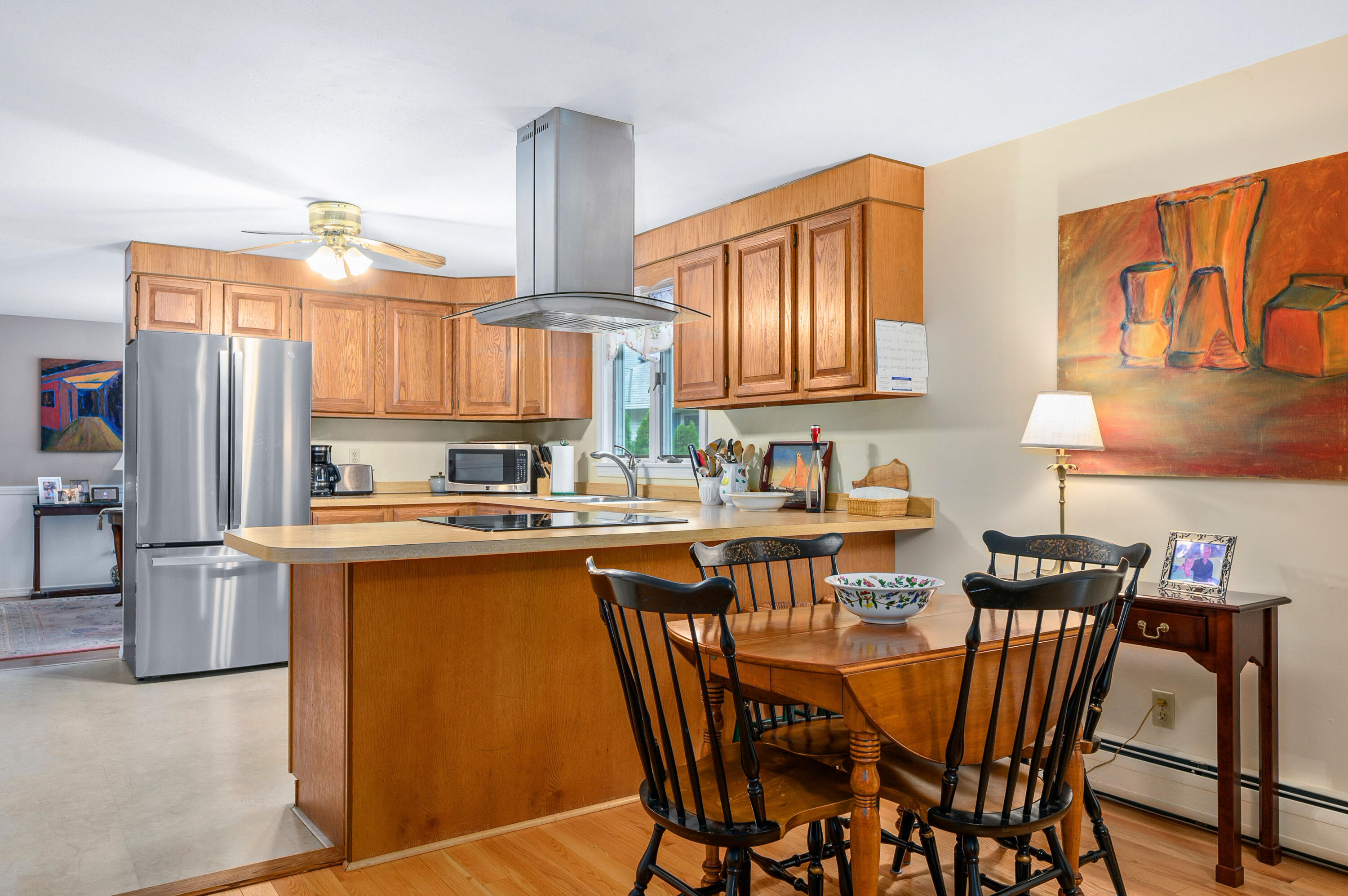 167 James Otis Road Centerville, MA 02632 - Photo 11 of 36 a kitchen with stainless steel appliances granite countertop a stove top oven a sink dishwasher and a refrigerator with wooden cabinets