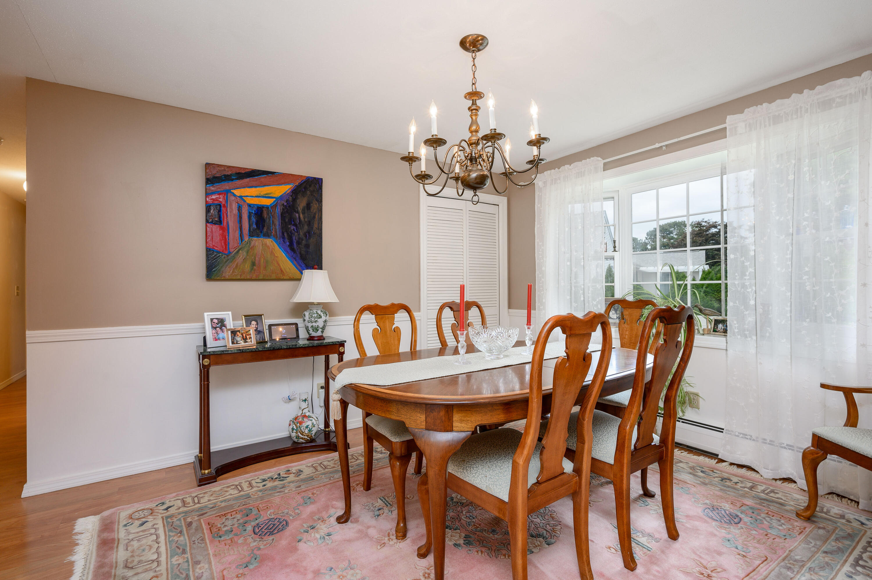 167 James Otis Road Centerville, MA 02632 - Photo 25 of 36 a dining room with furniture a chandelier and wooden floor