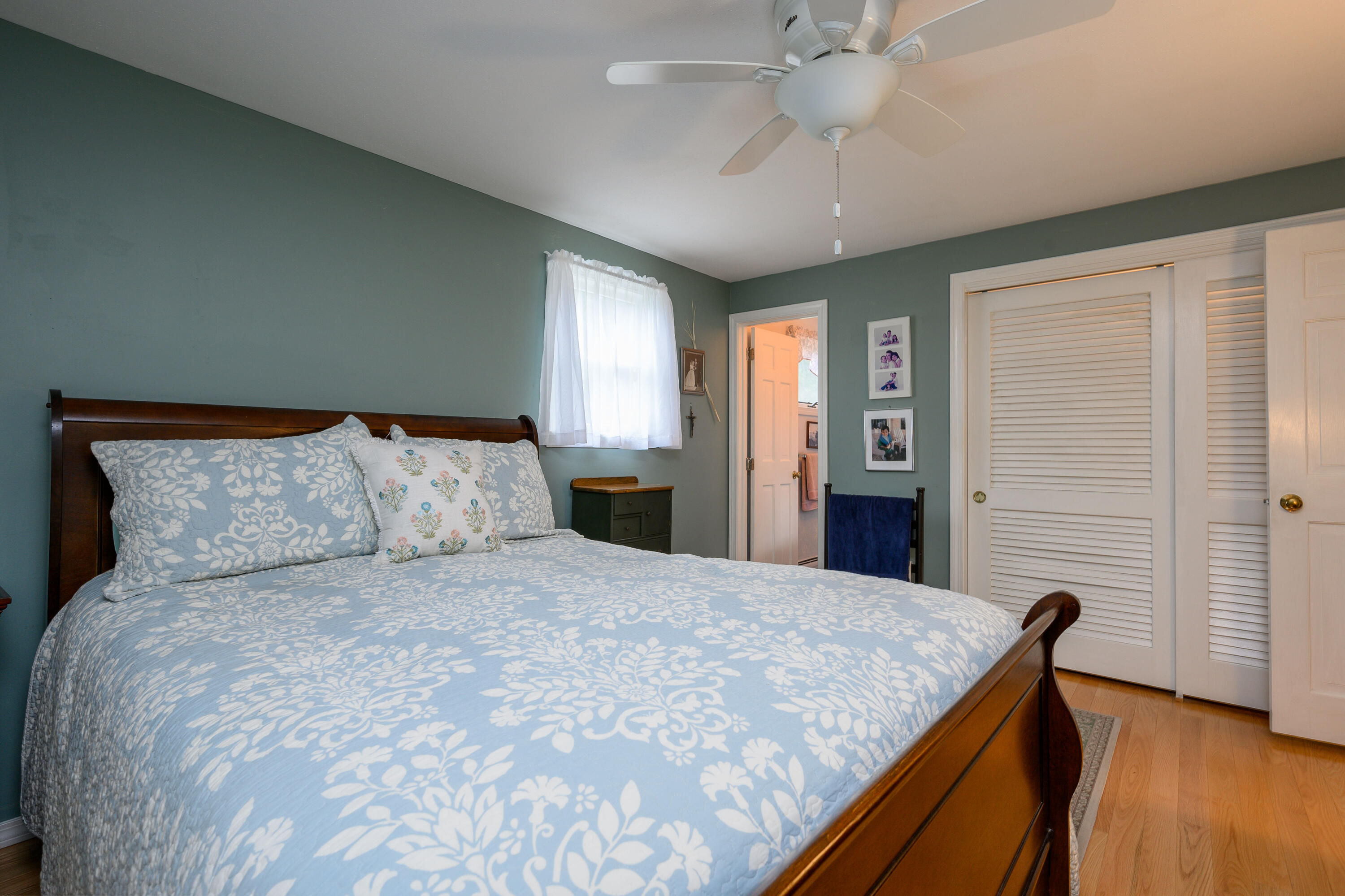167 James Otis Road Centerville, MA 02632 - Photo 29 of 36 a bedroom with a large bed and a chandelier