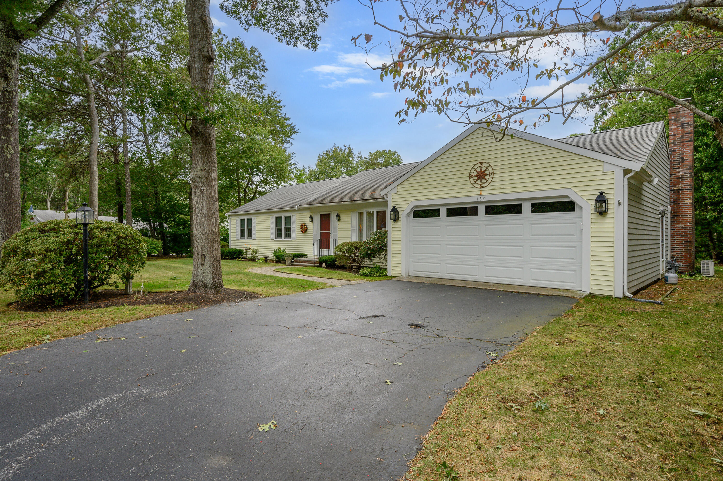 167 James Otis Road Centerville, MA 02632 - Photo 4 of 36 a front view of a house with a yard and garage