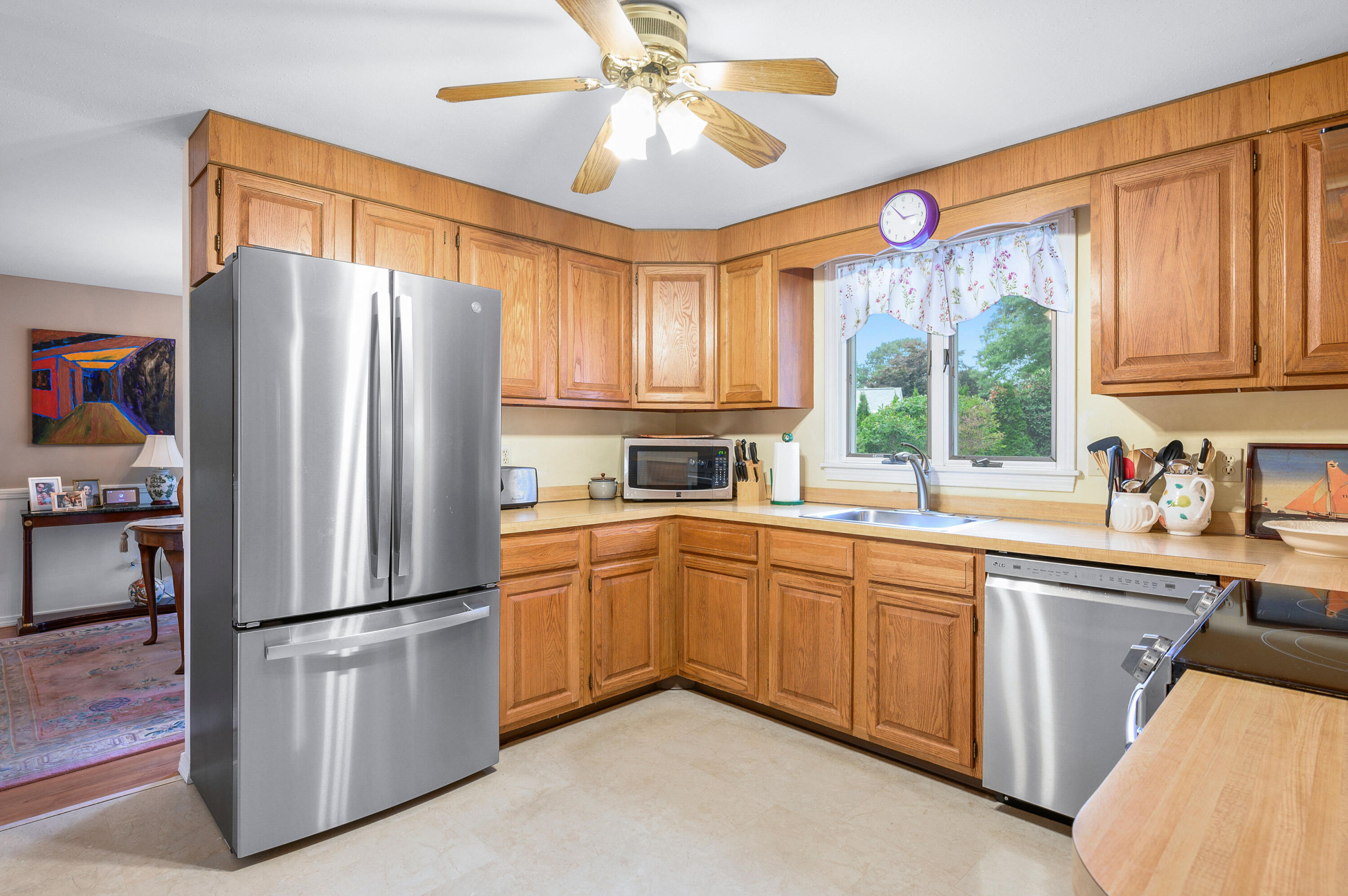 167 James Otis Road Centerville, MA 02632 - Photo 7 of 36 a kitchen with stainless steel appliances granite countertop a refrigerator a sink a stove and a window