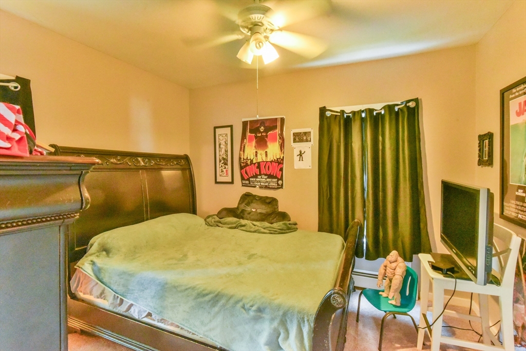 4 Agate Avenue Worcester, MA 01604 - Photo 27 of 39 a bedroom with a bed and chandelier