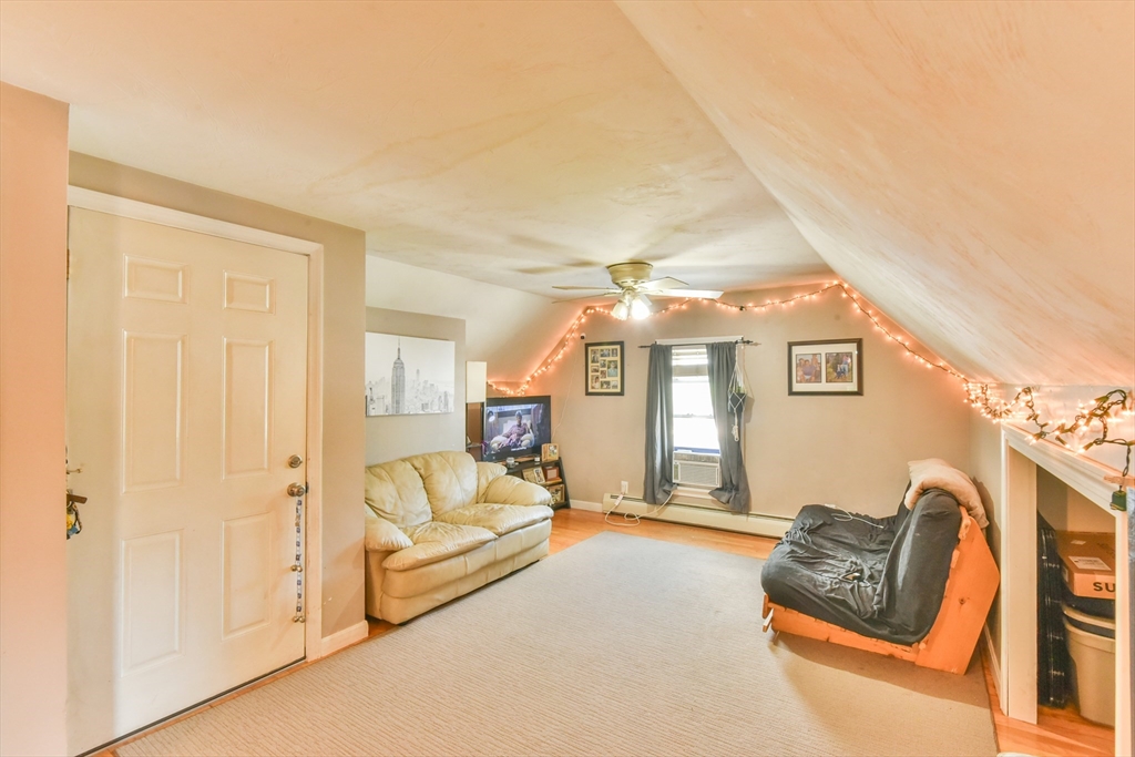 4 Agate Avenue Worcester, MA 01604 - Photo 32 of 39 a living room with furniture and a chandelier