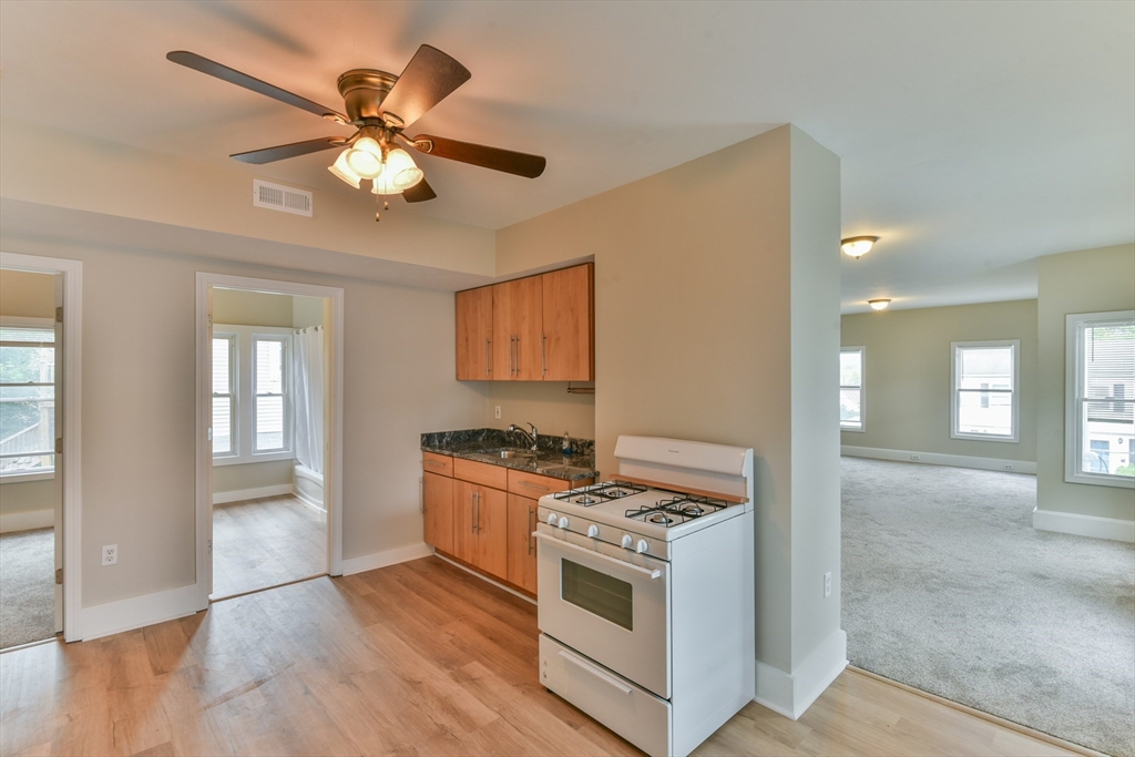 4 Agate Avenue Worcester, MA 01604 - Photo 7 of 39 a kitchen with stainless steel appliances granite countertop a stove and a white cabinets