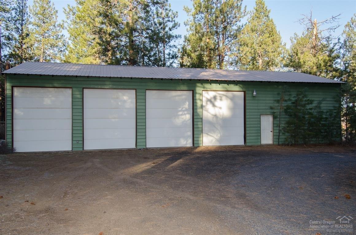 20903 Knott Road Bend, OR 97702 - Photo 21 of 23 a front view of a house with a yard and garage