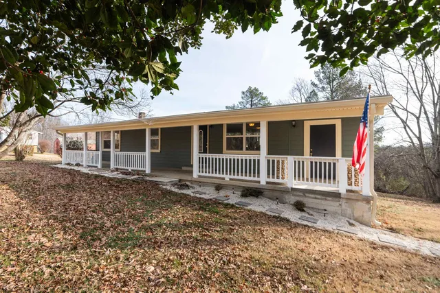 a view of a house with a swimming pool and deck