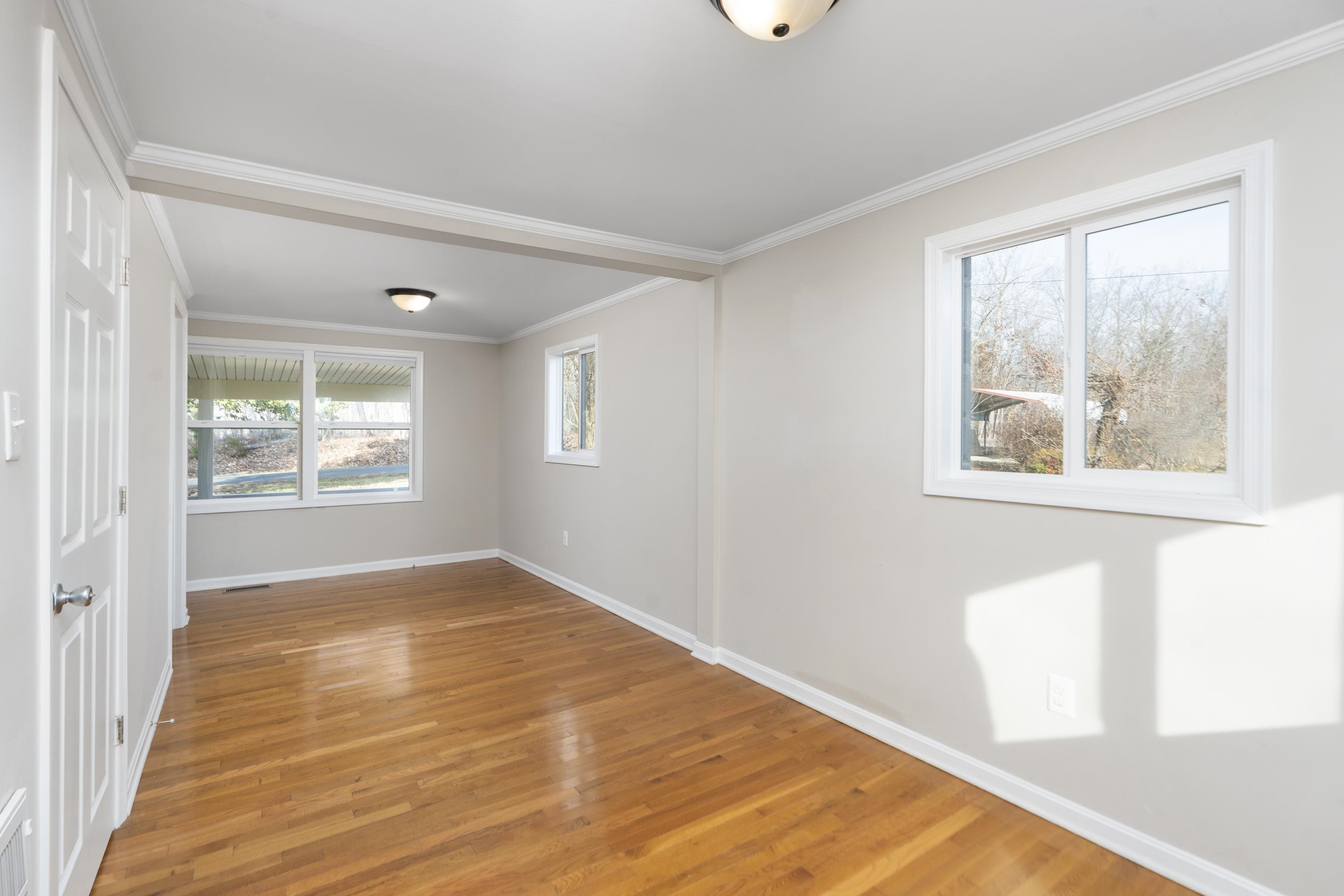 7081 Secretarys Sand Road Schuyler, VA 22969 - Photo 11 of 65 a view of an empty room with wooden floor and a window