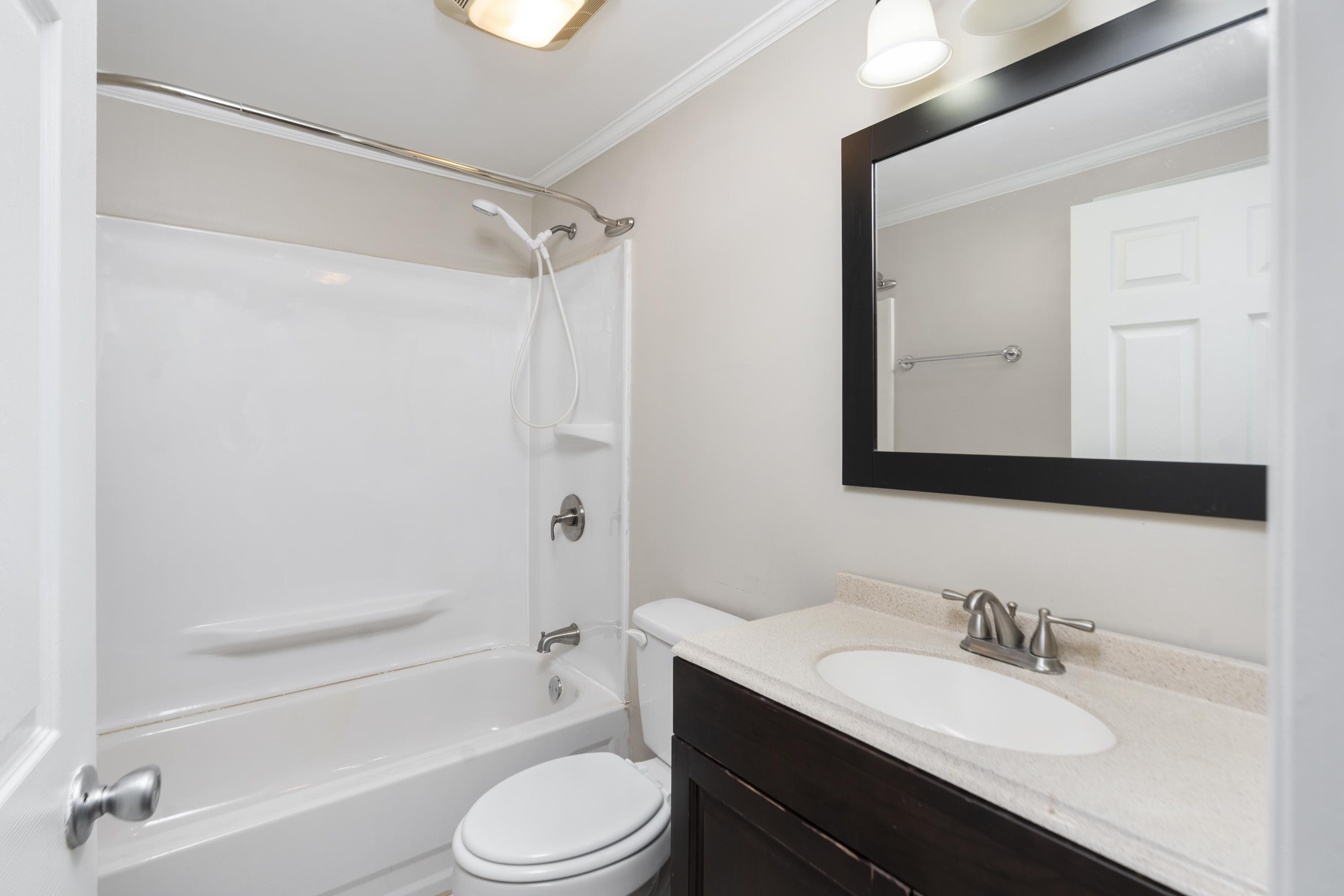7081 Secretarys Sand Road Schuyler, VA 22969 - Photo 13 of 65 a bathroom with a granite countertop sink toilet a mirror and shower