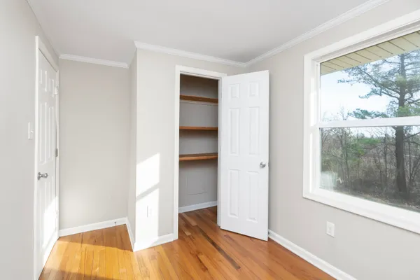 wooden floor in an empty room with a window