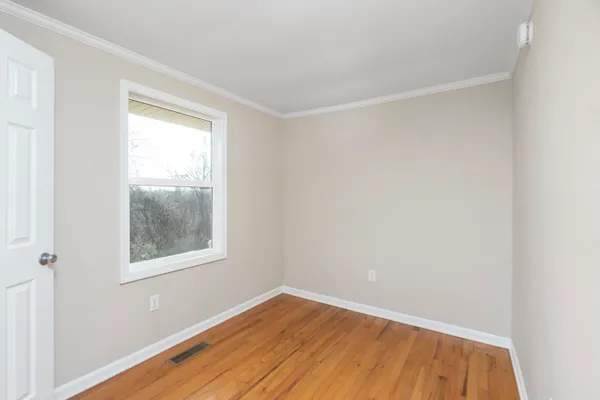 a view of a kitchen with a sink dishwasher a refrigerator with wooden floor and a kitchen view