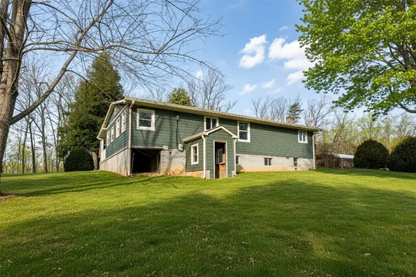 an aerial view of a house with yard and parking space