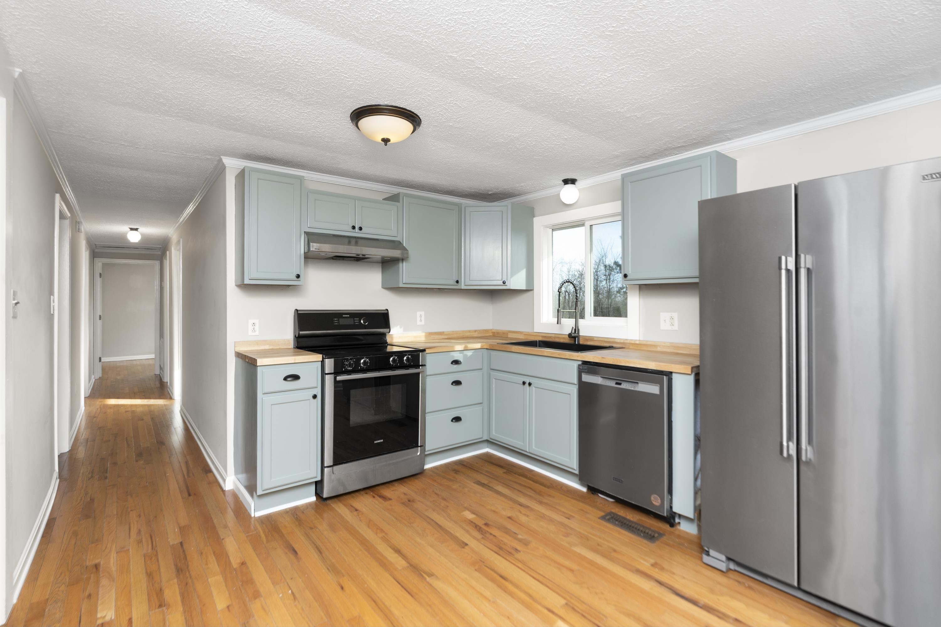 7081 Secretarys Sand Road Schuyler, VA 22969 - Photo 5 of 65 a kitchen with a refrigerator and a stove top oven