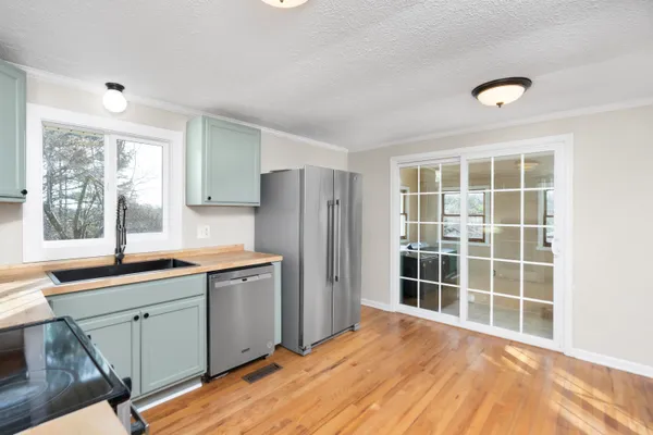 a kitchen with granite countertop a stove and a sink