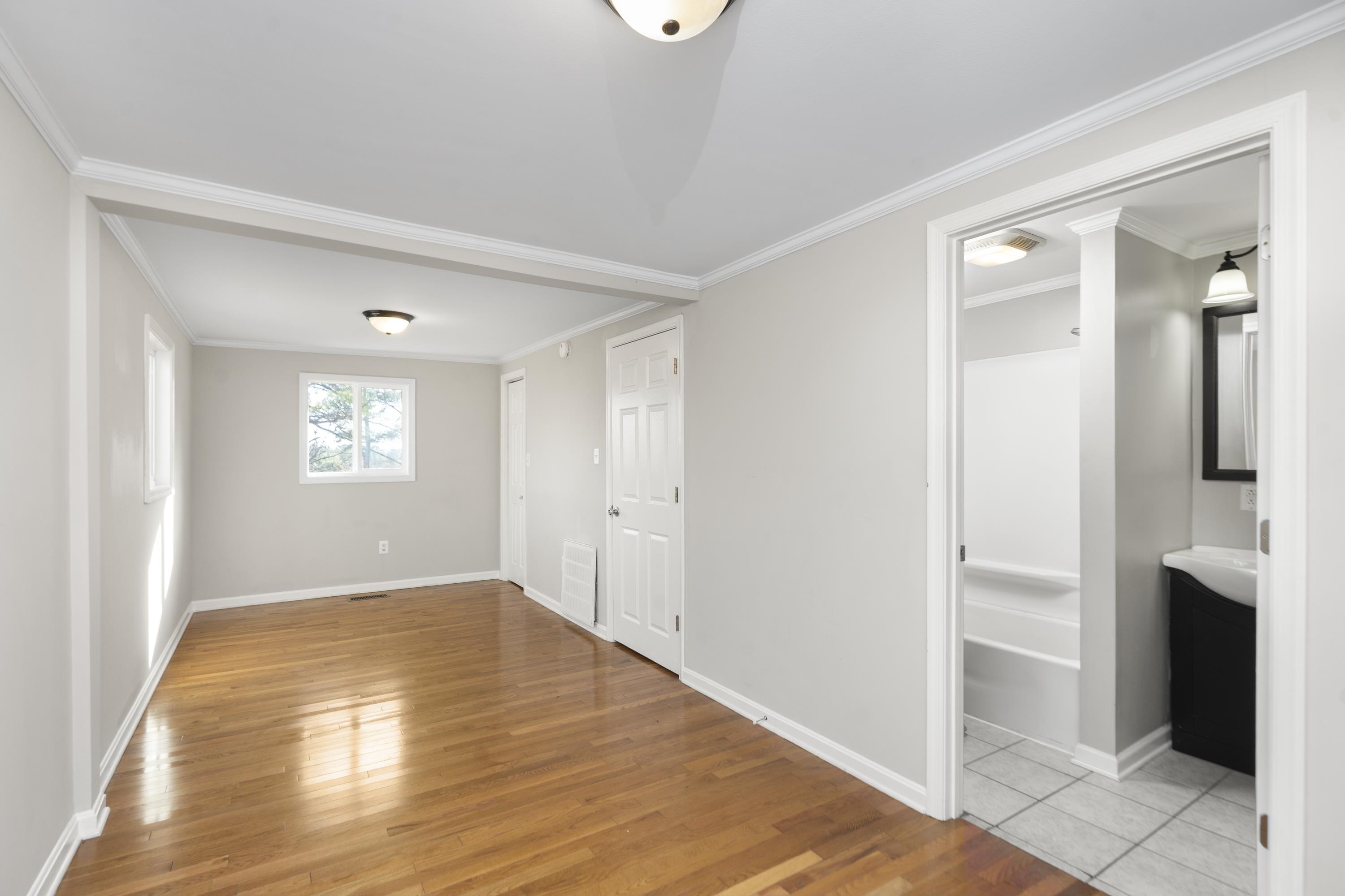 7081 Secretarys Sand Road Schuyler, VA 22969 - Photo 10 of 65 a view of empty room with wooden floor and fan