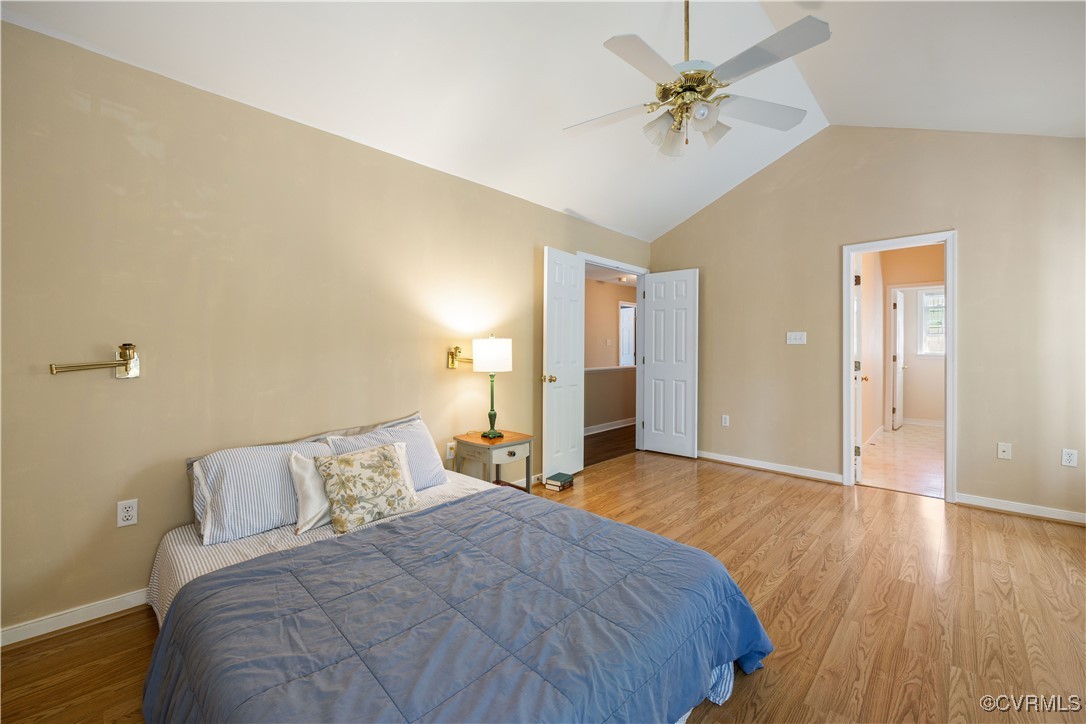 15221 Windy Ridge Road Midlothian, VA 23112 - Photo 15 of 30 a spacious bedroom with a bed and a chandelier