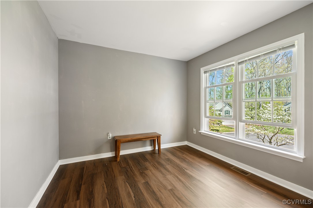 15221 Windy Ridge Road Midlothian, VA 23112 - Photo 17 of 30 a view of an empty room with wooden floor and a window