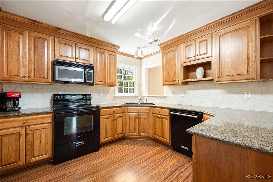 15221 Windy Ridge Road Midlothian, VA 23112 - Photo 7 of 30 a kitchen with stainless steel appliances granite countertop wooden cabinets stove top oven and granite counter top