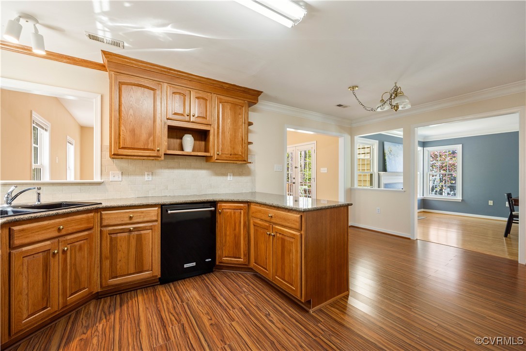 15221 Windy Ridge Road Midlothian, VA 23112 - Photo 8 of 30 a kitchen with stainless steel appliances granite countertop wooden cabinets a stove top oven a sink and dishwasher with wooden floor