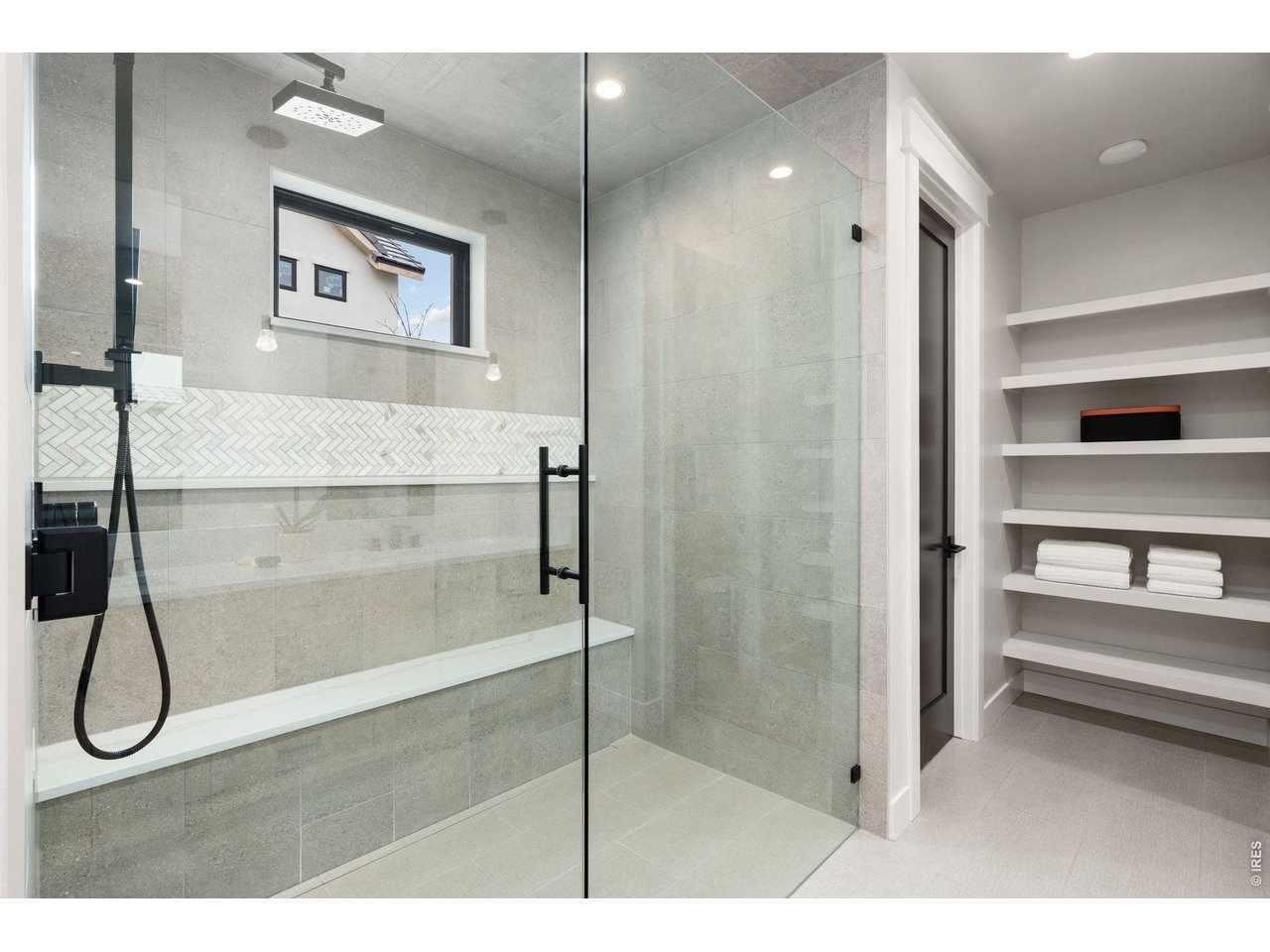 2311 Sugarloaf Road Berthoud, CO 80513 - Photo 14 of 49 a bathroom with a glass shower door