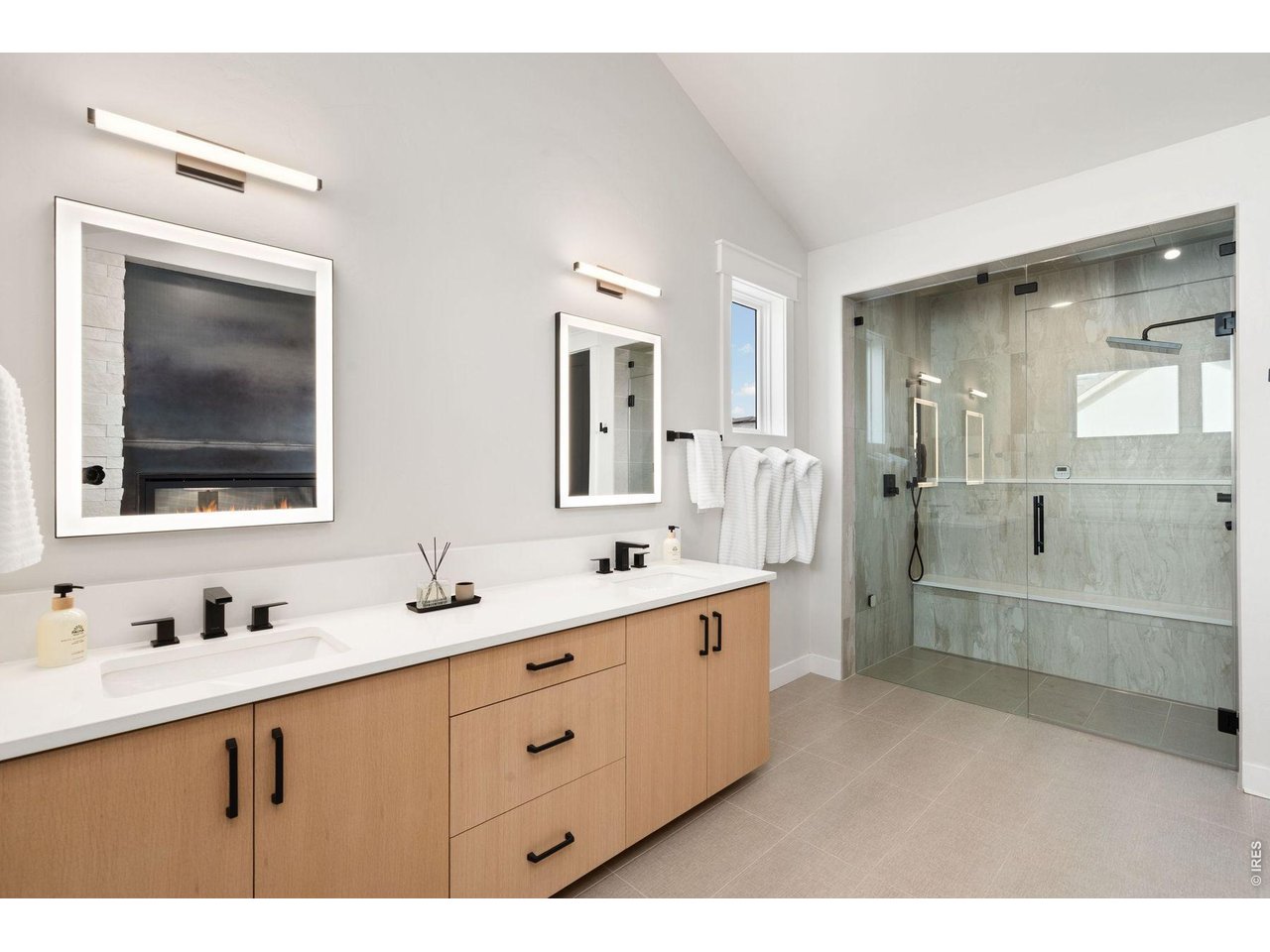 2311 Sugarloaf Road Berthoud, CO 80513 - Photo 23 of 49 a bathroom with a double vanity sink mirror and shower