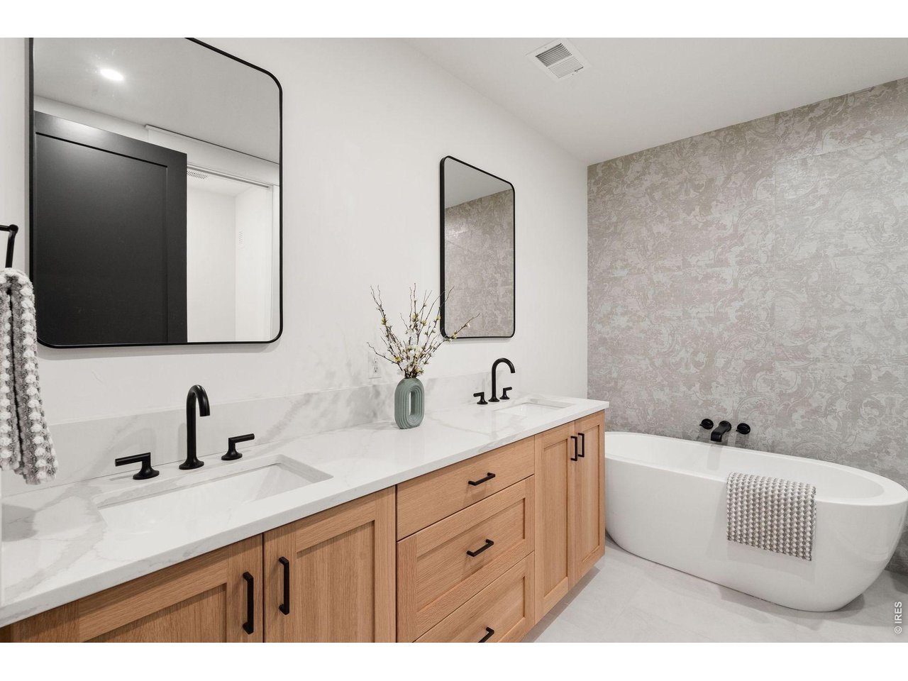 2311 Sugarloaf Road Berthoud, CO 80513 - Photo 43 of 49 a bathroom with a double vanity sink mirror and bathtub